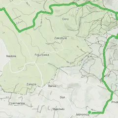 Mapa z zaznaczoną trasą turystyczną przez wzgórza i lasy, z nazwami miejscowości i rezerwatu.