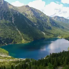 Malownicze Morskie Oko, idealne na górską trasę. Otoczone zielonymi lasami i skalistymi szczytami, zachwyca spokojną taflą wody.